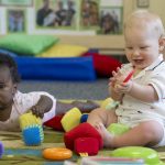 Infants play with blocks, balls and other colorful toys in CEHD’s Early Learning Center.