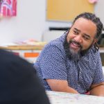 Roderick. L. Carey, CEHD associate professor, works with Delaware high school students at the Delaware Art Museum.