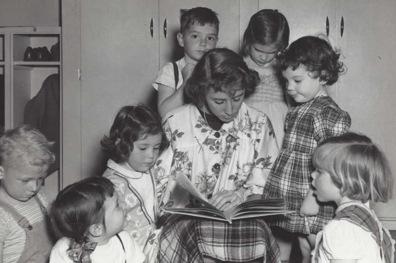 A UD student teacher reads to a group of children at CEHD’s Lab School in the 1950s.