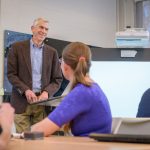 James Hiebert, professor emeritus in UD’s College of Education and Human Development, talks with mathematics education doctoral students during a graduate seminar.