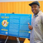 Each year, the International Student Essay Contest provides international students with a platform to share their perspectives with the greater University community. Pictured is Audin Francois, second place winner in the graduate student category, with a poster of his essay on display in Trabant University Center during International Education Week.