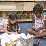 Preschool children play with figurines and horses at the College of Education and Human Development’s Early Learning Center.